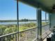 Relaxing screened lanai with a beautiful waterfront view and lush greenery at 10350 Longshore Rd # 61, Placida, FL 33946