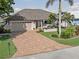 Single-story home with a large driveway and tropical landscaping at 1330 Appian Dr, Punta Gorda, FL 33950