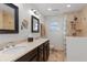 Main bathroom with double sinks, walk-in shower, and updated fixtures at 1330 Appian Dr, Punta Gorda, FL 33950