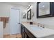 Bathroom with double vanity, dark brown cabinets, and a beige marble countertop at 1330 Appian Dr, Punta Gorda, FL 33950