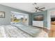 Bright bedroom with water views, a large TV, and hardwood floors at 1330 Appian Dr, Punta Gorda, FL 33950