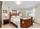 Bedroom with wood bed frame and neutral-toned bedding at 1330 Appian Dr, Punta Gorda, FL 33950