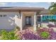 Elegant home entrance with a decorative door and lush landscaping at 1330 Appian Dr, Punta Gorda, FL 33950