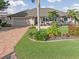 Single-story home with landscaped yard and brick driveway at 1330 Appian Dr, Punta Gorda, FL 33950