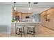 Modern kitchen with breakfast bar, stainless steel appliances, and light wood cabinets at 1330 Appian Dr, Punta Gorda, FL 33950