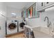 Bright laundry room with washer, dryer, and utility sink at 1330 Appian Dr, Punta Gorda, FL 33950
