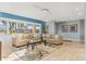 Bright living room with bay windows, two sofas, and tile flooring at 1330 Appian Dr, Punta Gorda, FL 33950