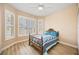 Charming bedroom with an antique bed, wood-style flooring, and ample natural light at 15341 Mille Fiore Blvd, Port Charlotte, FL 33953