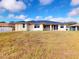Another angle of the home's backyard, showing the grassy expanse and exterior at 158 Eppinger Dr, Port Charlotte, FL 33953