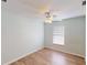 Light blue bedroom with wood-look floors and a ceiling fan at 158 Eppinger Dr, Port Charlotte, FL 33953
