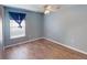Light blue bedroom with wood-look floors, ceiling fan, and window coverings at 158 Eppinger Dr, Port Charlotte, FL 33953