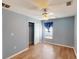 Blue bedroom with laminate floors, ceiling fan, and closet at 158 Eppinger Dr, Port Charlotte, FL 33953