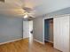 Bedroom with light blue walls, wood-look floors, ceiling fan, and a large closet at 158 Eppinger Dr, Port Charlotte, FL 33953