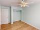 Bedroom with light blue walls, wood-look floors, ceiling fan, and a closet at 158 Eppinger Dr, Port Charlotte, FL 33953