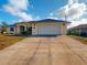 Home exterior showcasing a large attached garage and driveway at 158 Eppinger Dr, Port Charlotte, FL 33953
