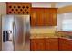 Kitchen boasts stainless steel refrigerator and wood cabinets at 158 Eppinger Dr, Port Charlotte, FL 33953