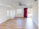 Living room with wood-look floors, ceiling fan, and access to backyard at 158 Eppinger Dr, Port Charlotte, FL 33953