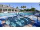 Enjoy this community pool area with a hot tub, lounge chairs, and manicured tropical landscaping at 1796 Scarlett Ave, North Port, FL 34289