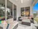 Comfortable screened patio with cushioned seating and a view of the garden at 1796 Scarlett Ave, North Port, FL 34289