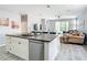 Open concept kitchen and living room with an island, stainless steel appliances, and granite countertops at 1796 Scarlett Ave, North Port, FL 34289