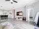 Spacious living room with hard surface floors, a ceiling fan, an arched doorway, and neutral walls at 1796 Scarlett Ave, North Port, FL 34289