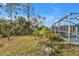 Screened-in pool and green space in unfenced backyard at 18359 Gypsy Ave, Port Charlotte, FL 33954