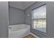 Guest bathroom with a soaking tub and blinds offering privacy at 18359 Gypsy Ave, Port Charlotte, FL 33954