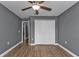Bedroom with ceiling fan, wood-look floors, and closet at 18359 Gypsy Ave, Port Charlotte, FL 33954