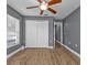 Bedroom with wood-look flooring, ceiling fan, and large closet at 18359 Gypsy Ave, Port Charlotte, FL 33954