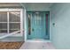 Close-up of a teal front door with sidelights at 18359 Gypsy Ave, Port Charlotte, FL 33954