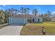 Charming blue home with attached two-car garage and landscaped front yard at 18359 Gypsy Ave, Port Charlotte, FL 33954