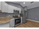 Modern kitchen with stainless steel appliances and white cabinets at 18359 Gypsy Ave, Port Charlotte, FL 33954