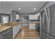 Contemporary kitchen featuring stainless steel appliances, ample counter space, and white cabinetry at 18359 Gypsy Ave, Port Charlotte, FL 33954