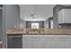 Kitchen with granite countertop, white cabinets, and a view into the living area at 18359 Gypsy Ave, Port Charlotte, FL 33954