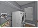 Laundry room with washer, dryer, and overhead storage at 18359 Gypsy Ave, Port Charlotte, FL 33954
