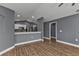 Open concept living area with wood-look floors, high ceiling, and view of the kitchen at 18359 Gypsy Ave, Port Charlotte, FL 33954