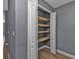 Pantry with white door and wooden shelves at 18359 Gypsy Ave, Port Charlotte, FL 33954
