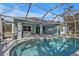 Pool area with screened enclosure and surrounding concrete decking at 18359 Gypsy Ave, Port Charlotte, FL 33954