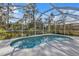 The screened-in pool with concrete decking provides relaxation in a backyard setting at 18359 Gypsy Ave, Port Charlotte, FL 33954