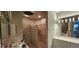 Bathroom with a glass block shower, dual vanities, and modern light fixtures at 197 Tropicana Dr # 1512, Punta Gorda, FL 33950