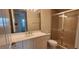 Bathroom with white vanity, sliding glass shower doors, and neutral tile at 197 Tropicana Dr # 1512, Punta Gorda, FL 33950