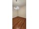 Empty bedroom with wood-look flooring and a stylish light fixture at 197 Tropicana Dr # 1512, Punta Gorda, FL 33950