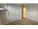 Bedroom with double closet doors, carpeted flooring, and open doorway at 197 Tropicana Dr # 1512, Punta Gorda, FL 33950
