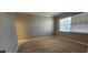 Spacious bedroom with large window, plush carpet, and soft gray walls at 197 Tropicana Dr # 1512, Punta Gorda, FL 33950
