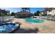 Community pool with a spa, lounge chairs, and a clubhouse, perfect for relaxation at 197 Tropicana Dr # 1512, Punta Gorda, FL 33950