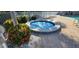 Soothing spa surrounded by vibrant tropical landscaping and white rock accents at 197 Tropicana Dr # 1512, Punta Gorda, FL 33950