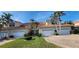 Two-story attached townhome with tile roof, white garage doors, and manicured lawn at 197 Tropicana Dr # 1512, Punta Gorda, FL 33950