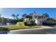 Building exterior by a pond, with lush landscaping and palm trees at 197 Tropicana Dr # 1512, Punta Gorda, FL 33950