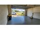 Garage interior with open door, showing driveway and parked car at 197 Tropicana Dr # 1512, Punta Gorda, FL 33950