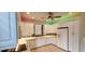 Kitchen with white cabinets, tile floor, and colorful lighting at 197 Tropicana Dr # 1512, Punta Gorda, FL 33950